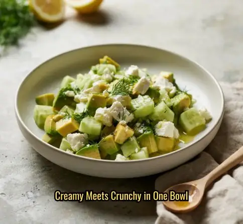 Avocado cucumber feta salad with fresh dill and olive oil, showing diced avocado and crumbled feta up close.
