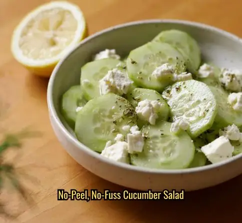  Persian cucumber feta salad with sliced mini cucumbers, feta crumbles, and a sprinkle of za'atar.
