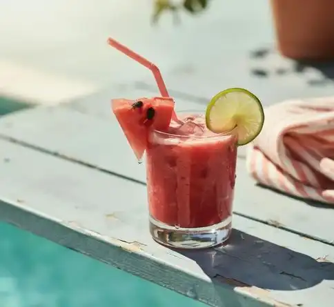 Healthy tropical watermelon lime smoothie garnished with watermelon and lime slices