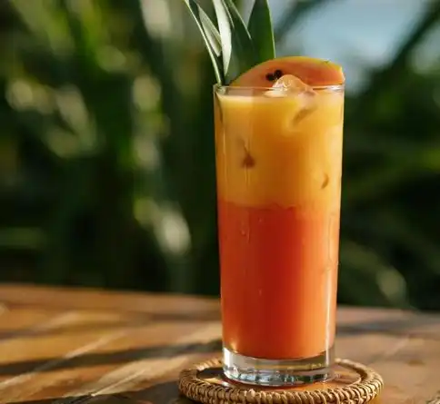 Layered tropical mixed fruit smoothie with mango, pineapple, and papaya