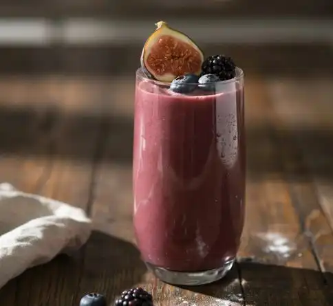 Fig berry mixed fruit smoothie recipe garnished with fresh halved figs