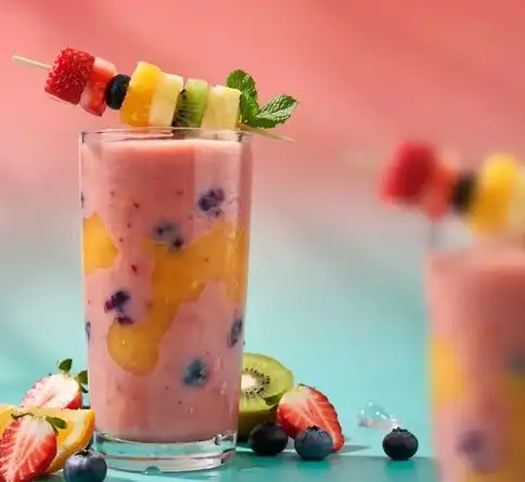 Ultimate mixed fruit smoothie recipe with a colorful fruit skewer garnish