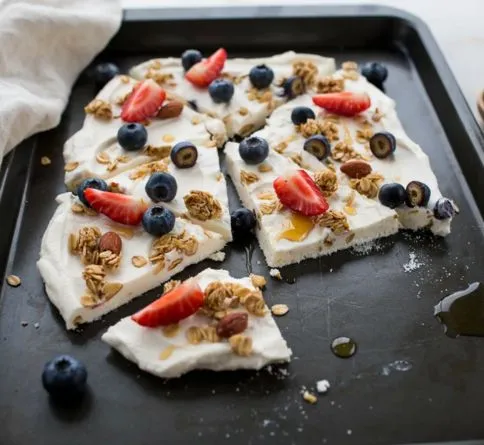 Frozen Greek yogurt bark with berries and granola, an easy no bake summer dessert for kids