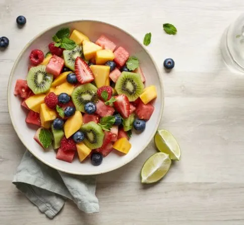 Fresh fruit salad with lime dressing, a healthy easy summer dessert for kids