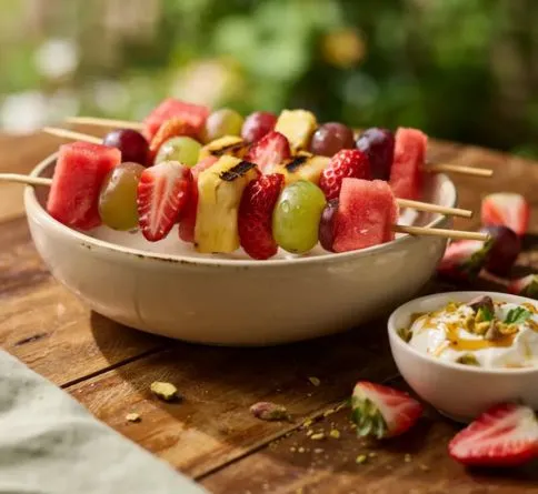 Colorful fruit kabobs with yogurt dip, a fun no bake summer dessert for kids