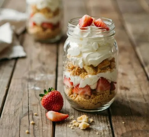 Strawberry shortcake jars with whipped cream, a fun summer dessert for kids