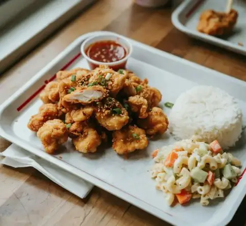 Crispy Hawaiian mochiko chicken made with sweet rice flour and served with rice and cabbage.