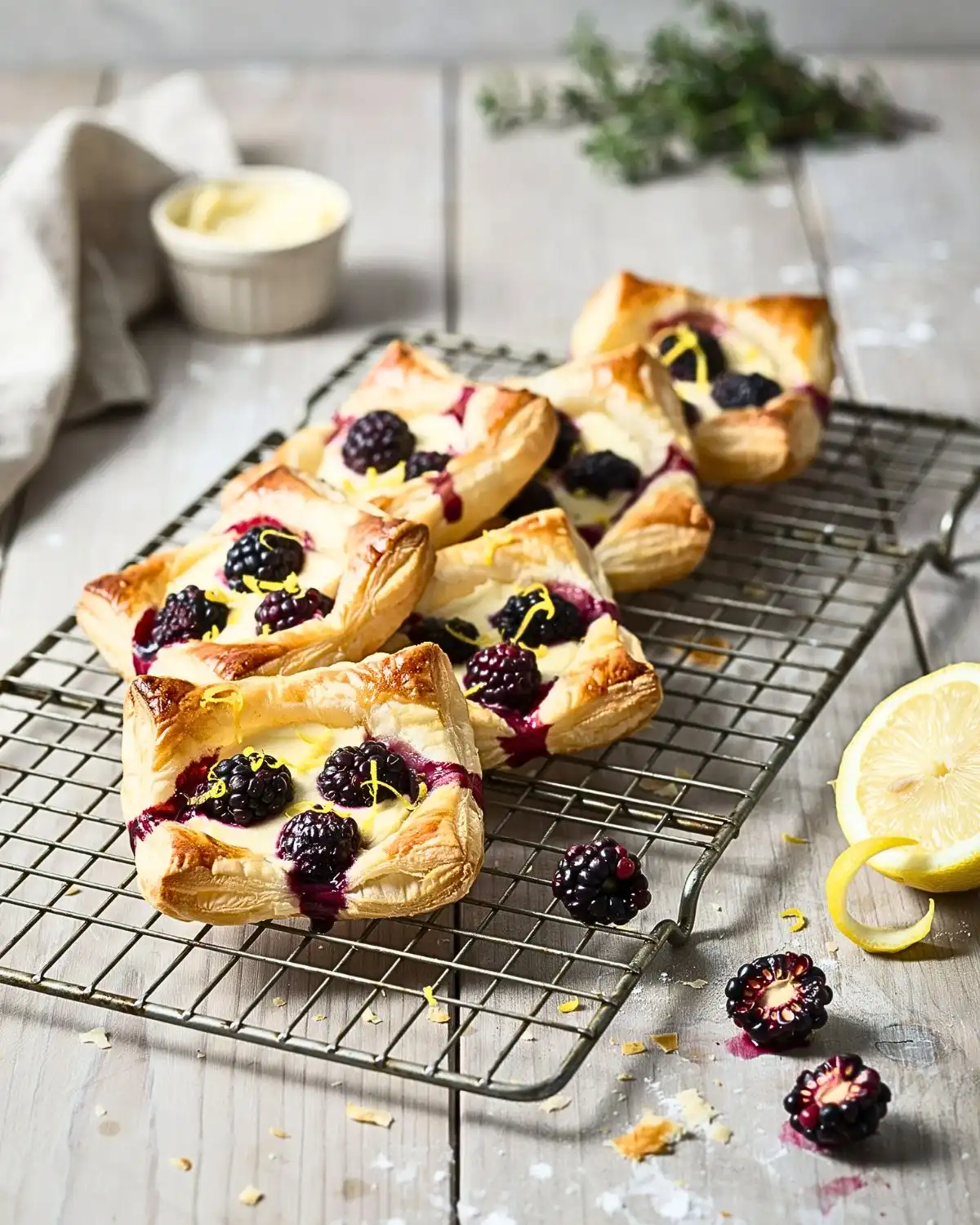 Individual blackberry cream cheese Puff Pastry Tarts with fresh blackberries and lemon zest.